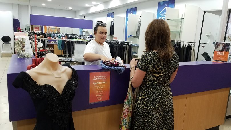 A volunteer serves a customer at Communities@Work's Best Dressed Store.
