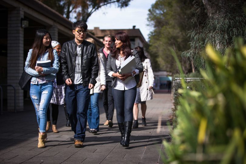 Group of international students walking on campus. 
