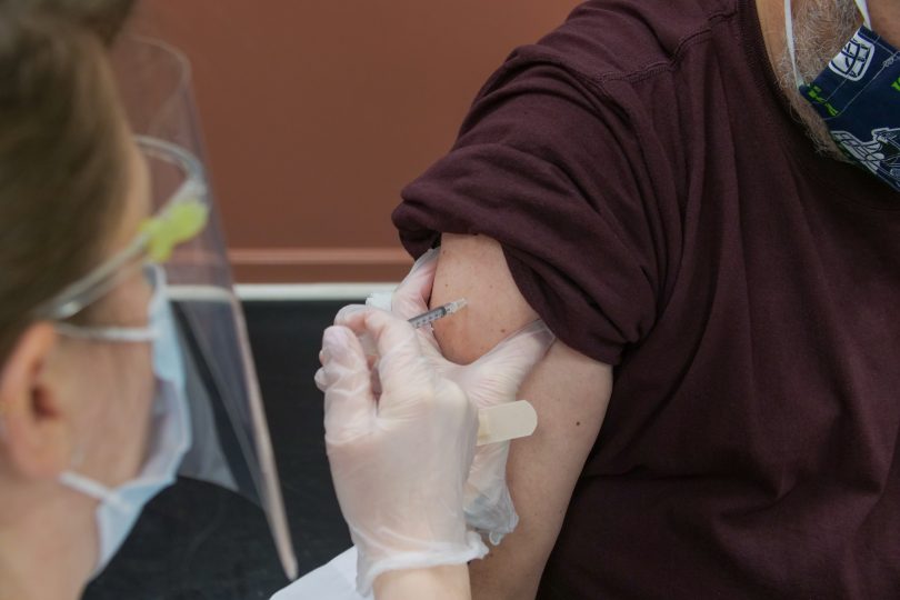 Vaccine needle going into arm