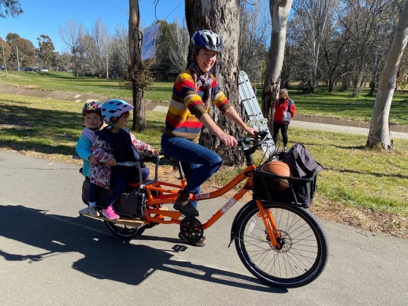 Woman and two children on electric bike in Canberra