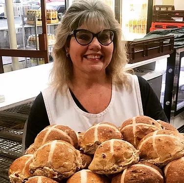 Katie Collins from Danny's Bakery holding hot cross buns.