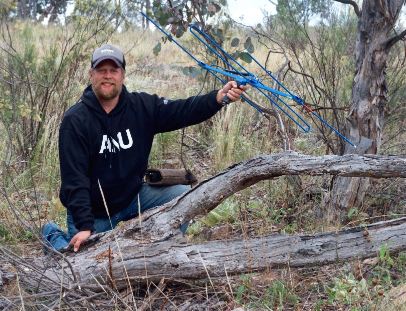 Snake researcher Gavin Smith with telemetry system in bush.