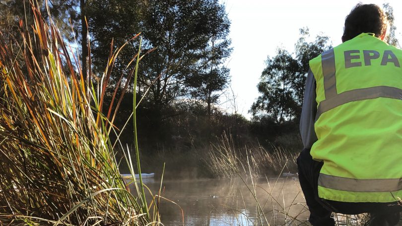 A NSW EPA officer checks pollution levels in the Molonglo River near Queanbeyan.