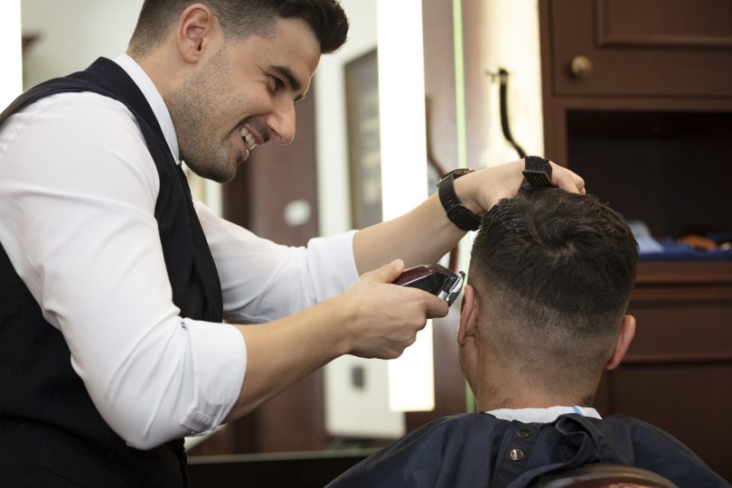 Man cutting another man's hair