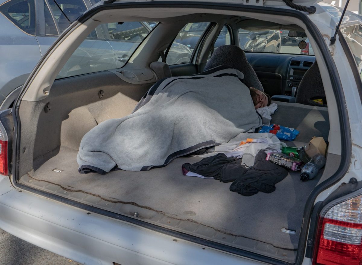 Homeless man sleeping in car