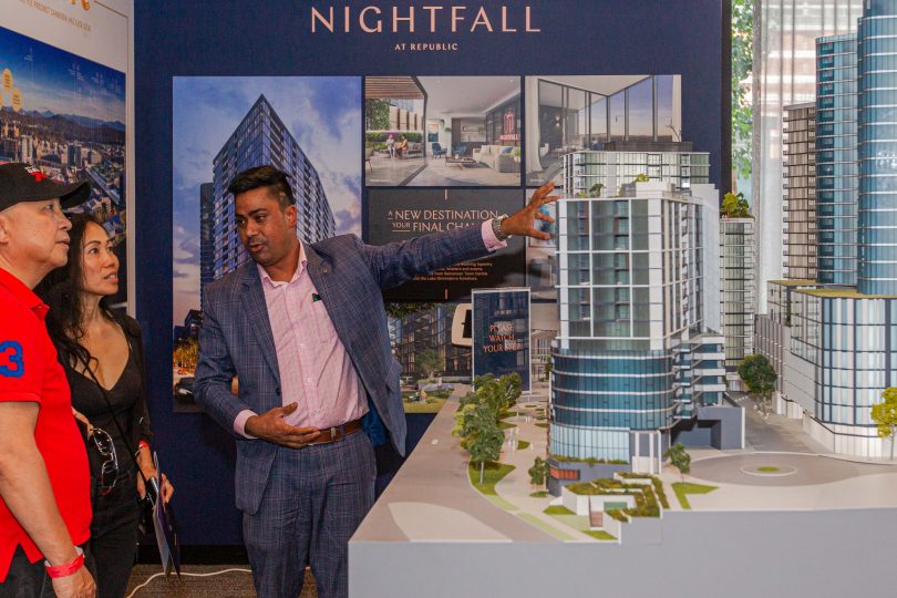 People looking at display model of Nightfall apartment complex