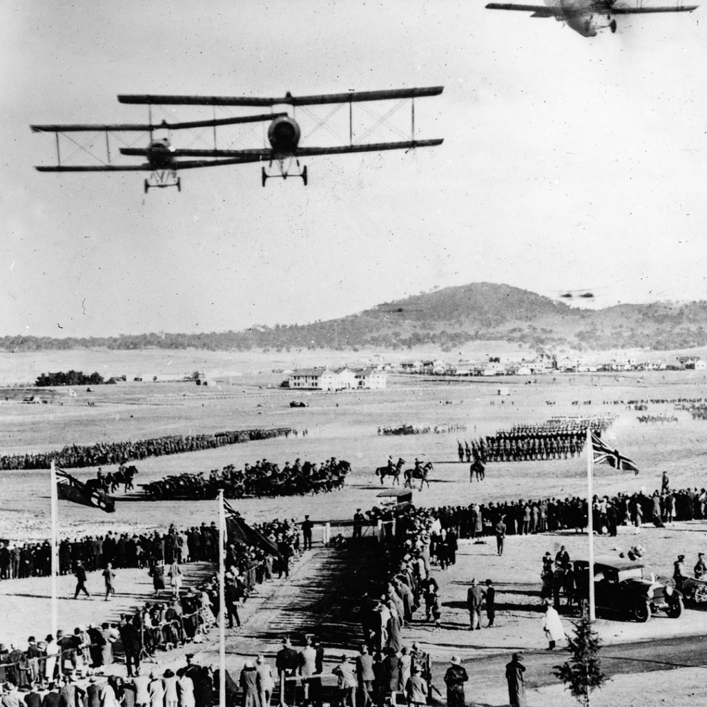 Biplanes over crowds
