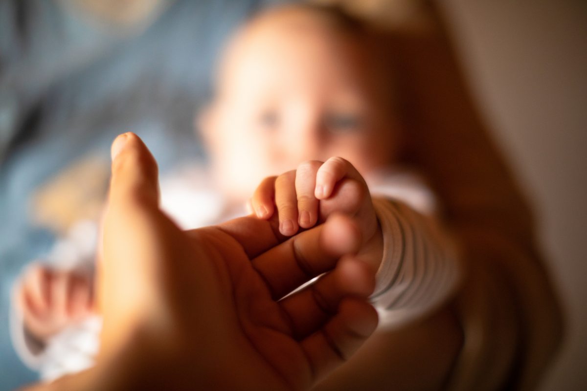 Infant holding a finger