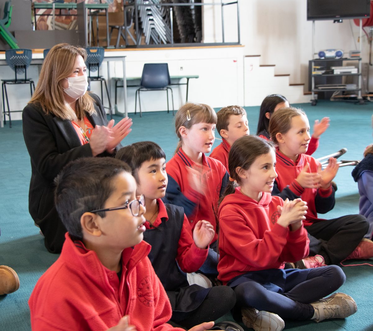 Minister for Education Yvette Berry with a group of Majura Primary School students enjoying a music lesson.