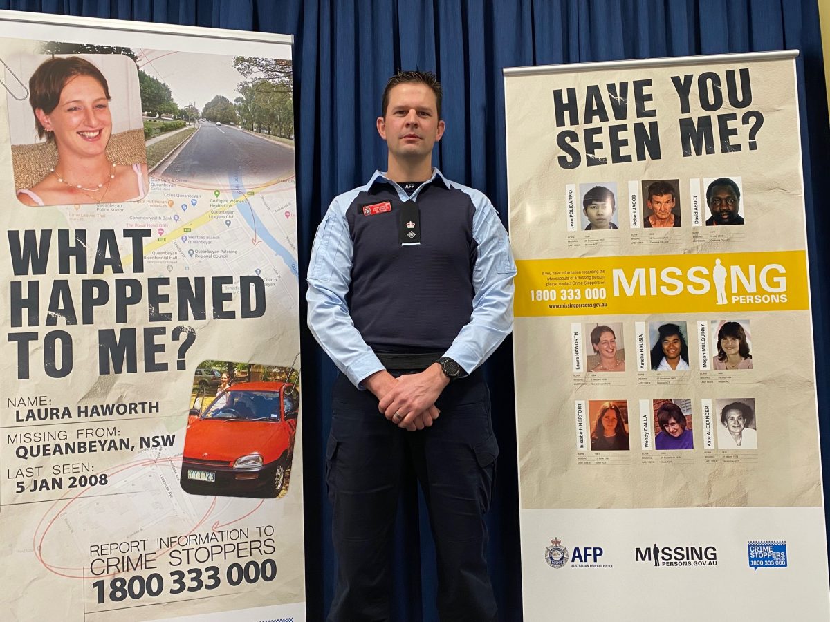 Detective Acting Inspector Paul Reynolds with missing person posters