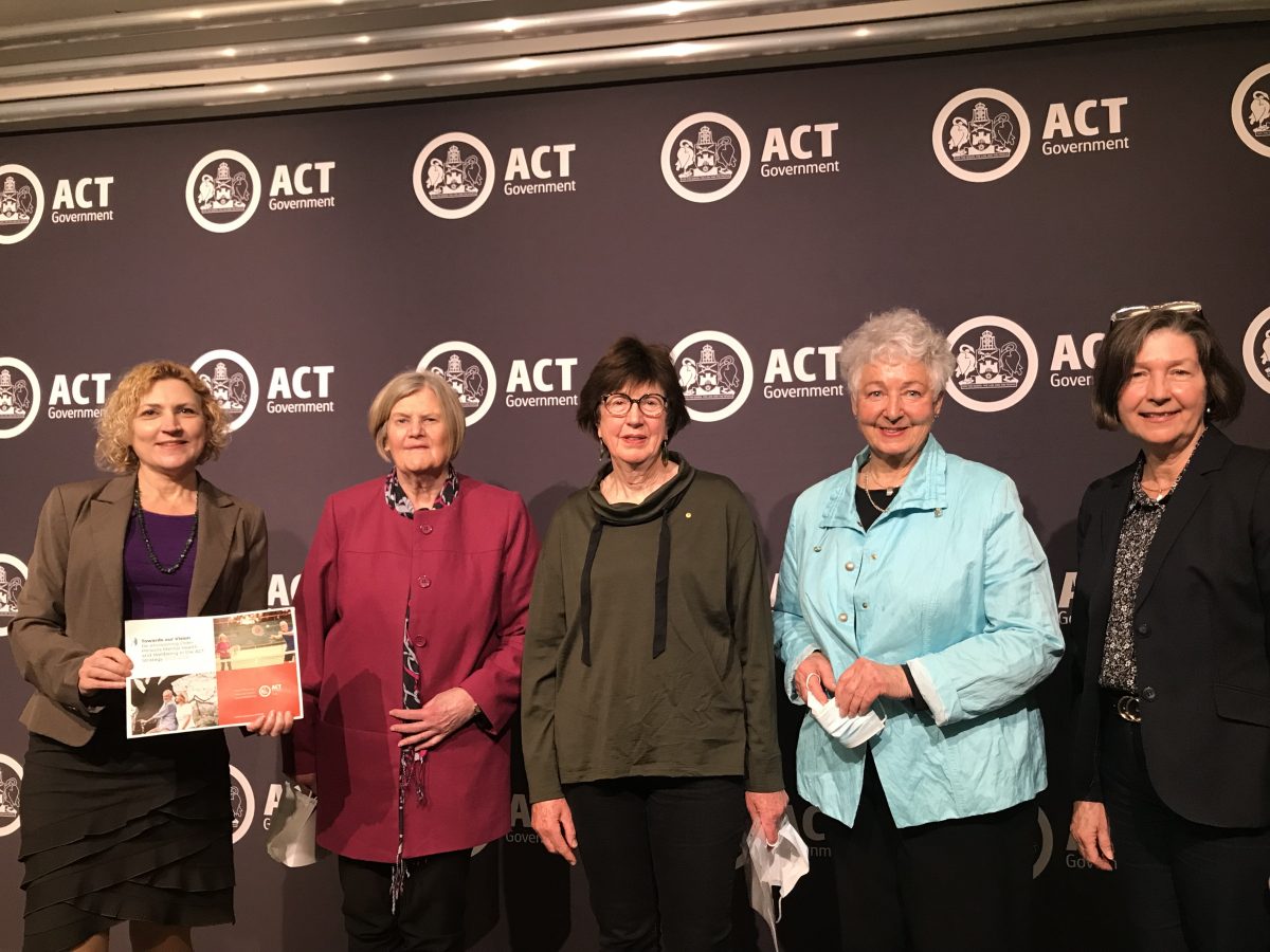 Five women standing in front of ACT Government banner