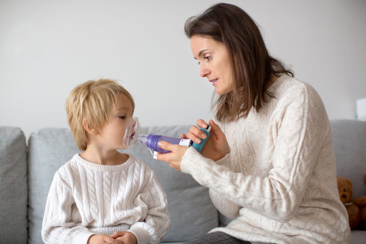 Child using asthma puffer
