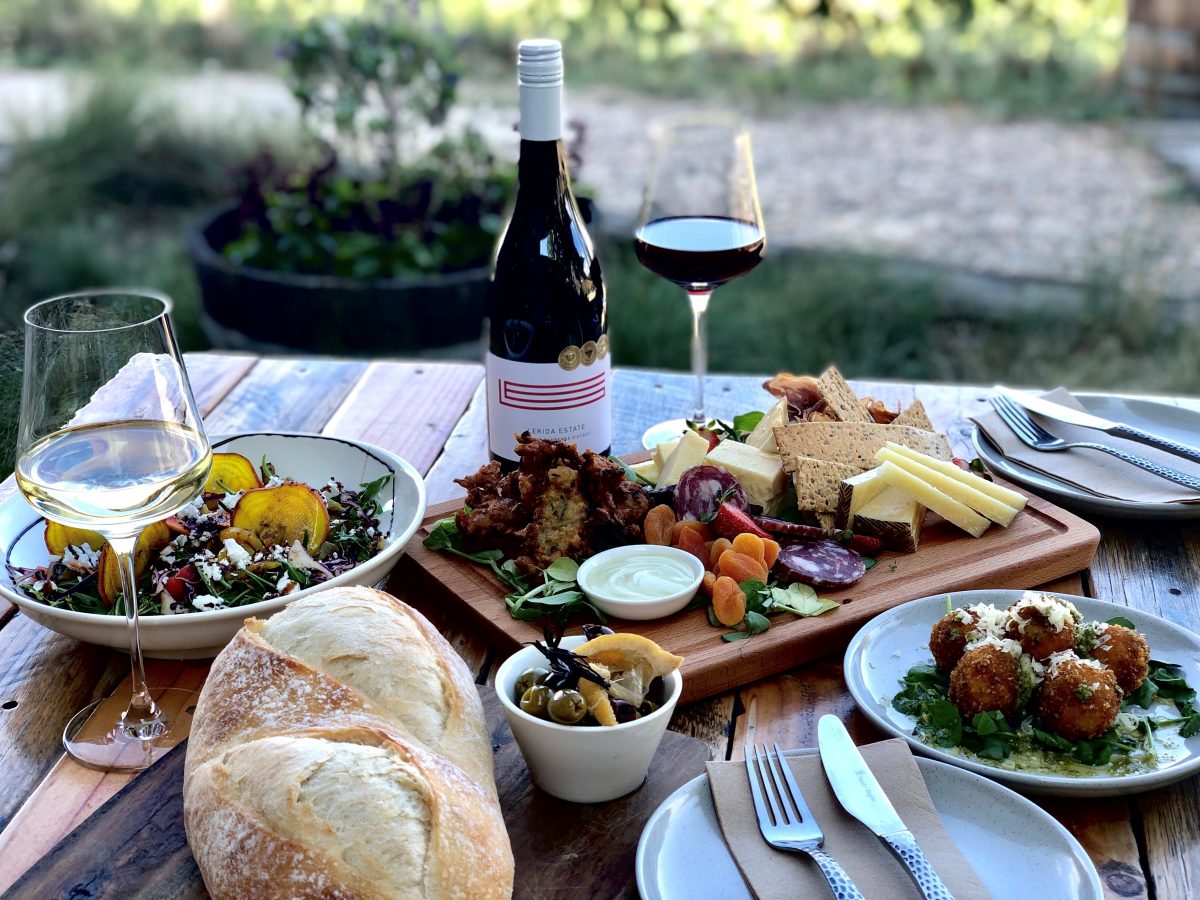 wine and food on a table at a vineyard