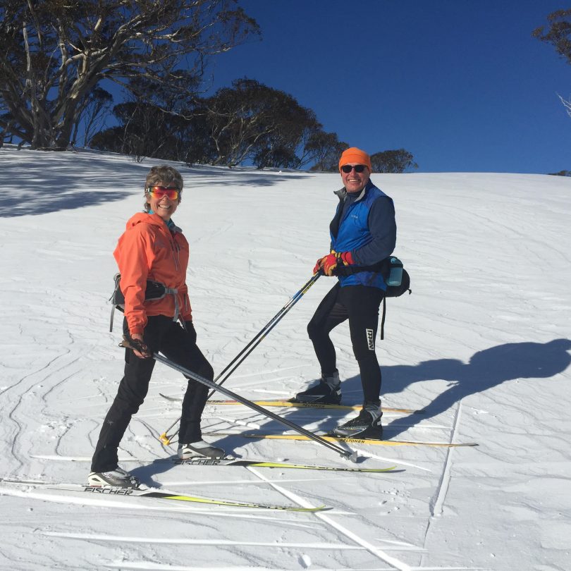 Acacia Rose (left) and Mike Edmondson (right) on standing on skis on snow.